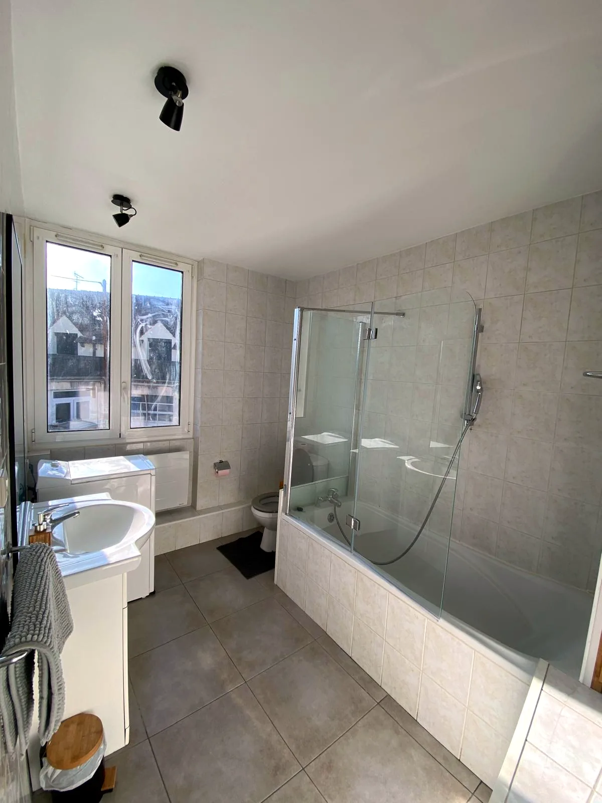 Salle de bain avec baignoire et lave-linge